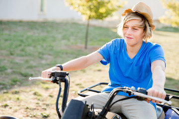 Obraz premium Boy riding farm truck in vineyard