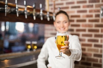 Barmaid holding a beer