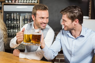 Men toasting while looking at each other