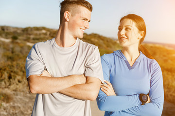 Young couple on beach in sportwear