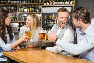 Friends toasting while looking at each other