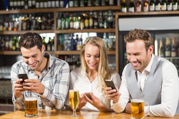 Friends looking at smart phones