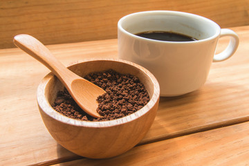 Instant coffee  in the wood bowl with white cup of coffee