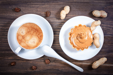 Espresso coffee in a ceramic bowl, basket waffle with peanut but