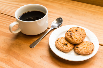 White cup of coffee with chocalate chips cookies 2