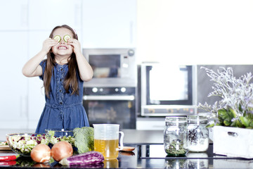 little daughter cooking in the kitchen