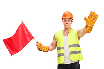 Construction worker waving a red flag