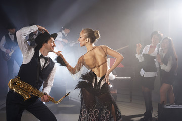 Girl dancing with saxophonist