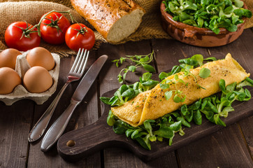 French omelet, fluffy, fresh eggs and herbs