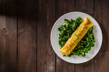 French omelet, fluffy, fresh eggs and herbs