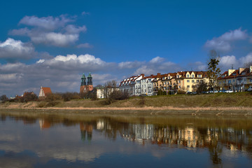 Fototapeta na wymiar Urban landscape with river Warta, the cathedral towers and residential houses in Poznan.