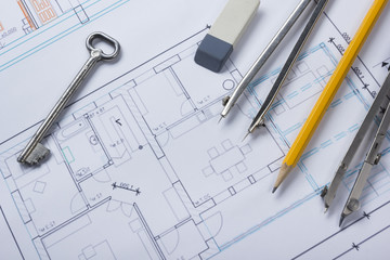 Architect worplace top view. Architectural project, blueprints, blueprint rolls and  divider compass, key, pencil card on plans. Construction background. Engineering tools. Copy space