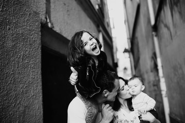 Mom and Dad holding happy children