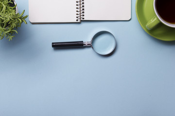 Office table with supply and coffe cup. View from above. Copy space for text