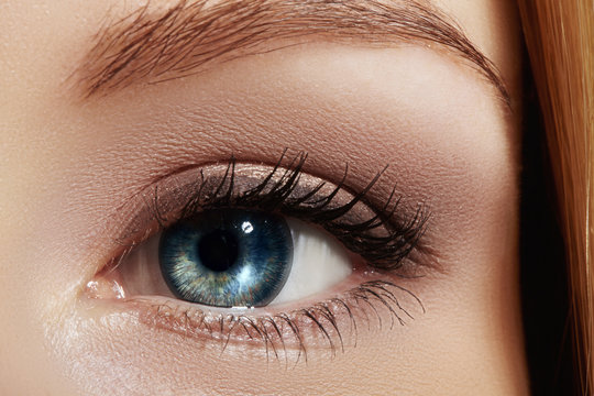 Clean vision, lens. Beautiful macro shot of female eye with classic smoky makeup. Cosmetics and make-up