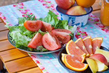 picnic, view of picnic table with fruits, juice and vegetable at the camping area