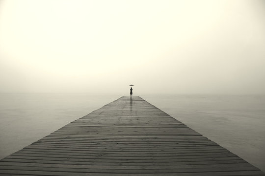 Woman With Black Umbrella Looking Infinity In A Surreal Place