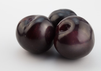 Plums on white