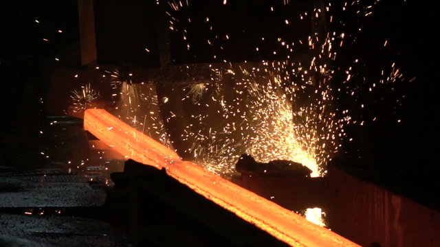 Sparks from the cutting of the red-hot billet circular saw