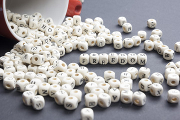 FREEDOM word on wood blocks concept. Wooden ABC