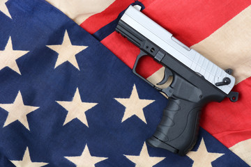 gun laying on a american flag