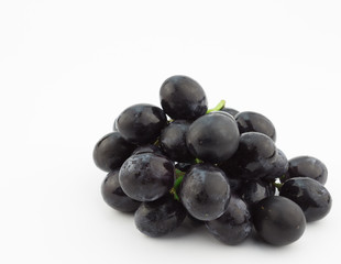 Small bunch of black grapes isolated on white background