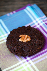 Round homemade brownies with walnuts on a rustic background