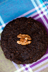 Round homemade brownies with walnuts on a rustic background