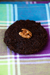 Round homemade brownies with walnuts on a rustic background