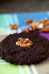 Round homemade brownies with walnuts on a rustic background
