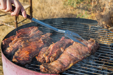 Closeup of grilled meat in the barbecue outdoors