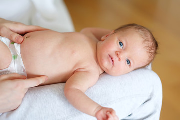 One month old newborn baby with mother