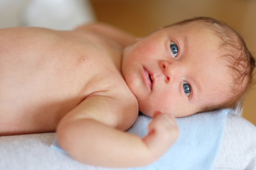 One month old newborn baby with mother