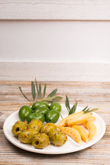 White board with giant  green olives and bread