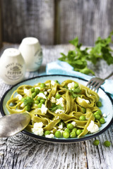 Spinach pasta with green pea and cheese.