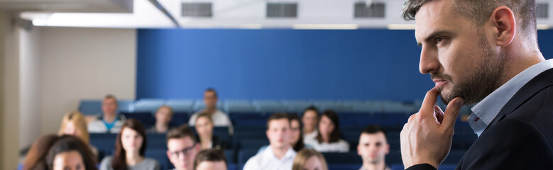 Young handsome man on business lecture