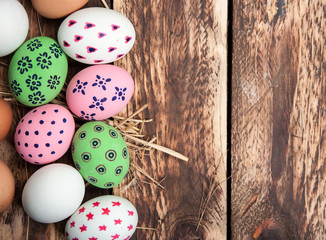 Easter eggs in nest on wooden background