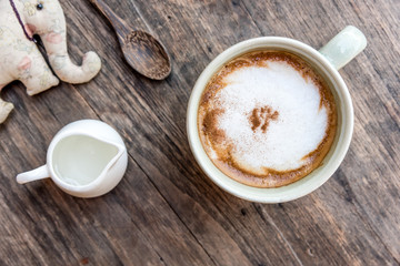  cappuccino coffee cup with mini jar of syrup and wooden spoon a