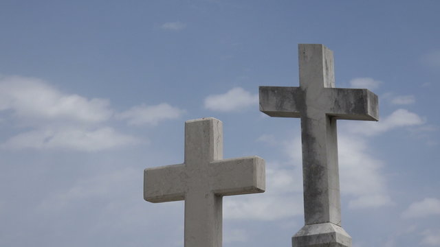 Two Christian crosses against sky