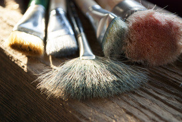 Verschiedene, gebrauchte Pinsel auf Holz / Treibholz Hintergrund 