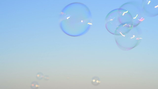 soap bubbles floating in the air as the summer sunsets