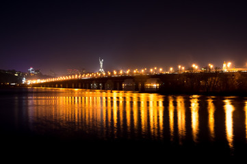 Fototapeta na wymiar Lights on the Kiev's bridge at night