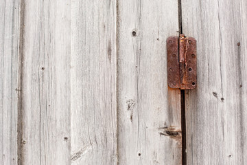 old rusty hinge on a wooden door
