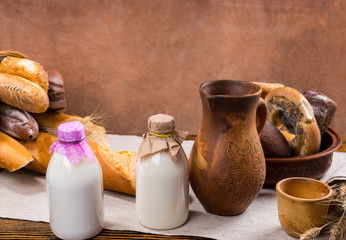 Milk, pitcher, cup and bread loaves