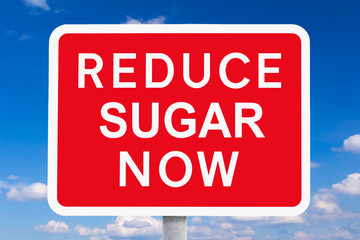 Red signpost REDUCE SUGAR NOW