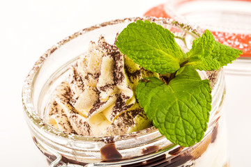 close-up ice cream in glass jar with mint leaves
