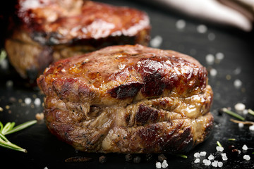 Grilled steak meat (mignon) on the dark surface