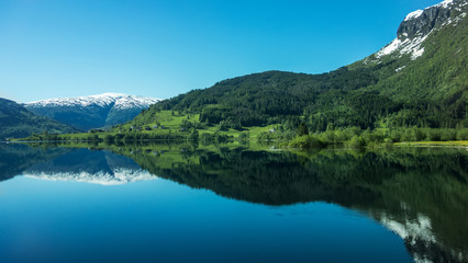 Naklejka na ściany i meble Magic reflection./ Mountains reflect in the lake. Norway