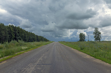dark storm clouds over the asphalt road