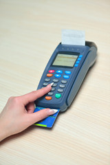 Girl pays purchase through the terminal pos